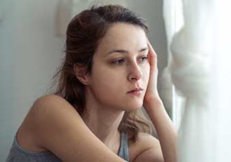 anxious woman looking out the window