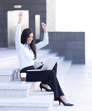 Successful Woman Sitting on Steps with Laptop